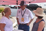 Dottie Worthington (left) and Lisa Catlin (right) converse with State Rep. Glenn Rogers at the Parker County Republican Women booth.