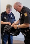 Tom kelly and Scott Jones prepare gear at the Pct. 4 Constable office.